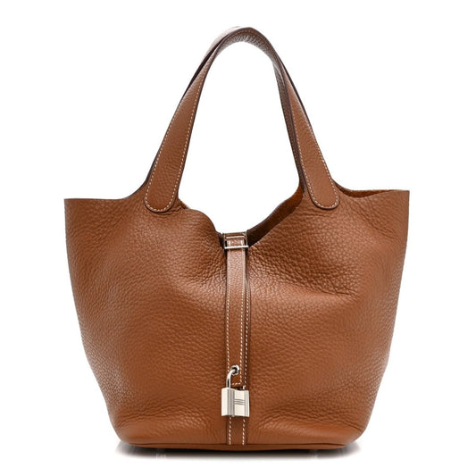 Gold leather tote bag with top handles and central metal lock clasp