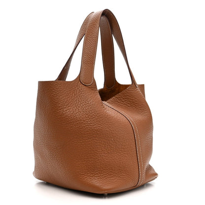 Gold leather tote bag with top handles and gusseted front body
