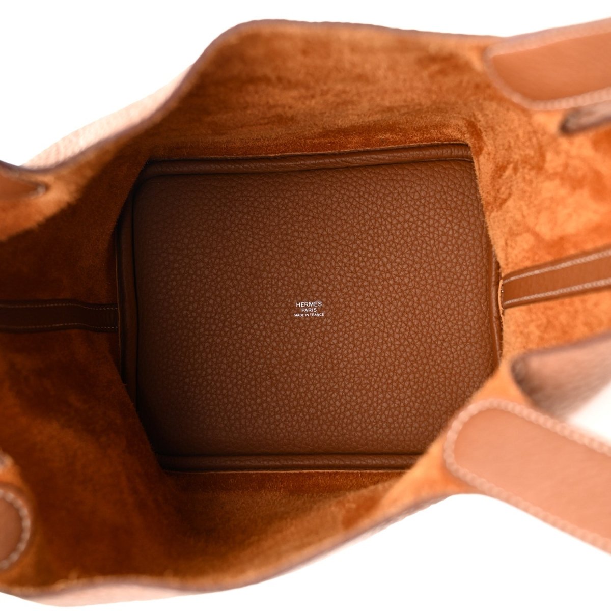 Leather tote bag interior with brown lining and zip pocket