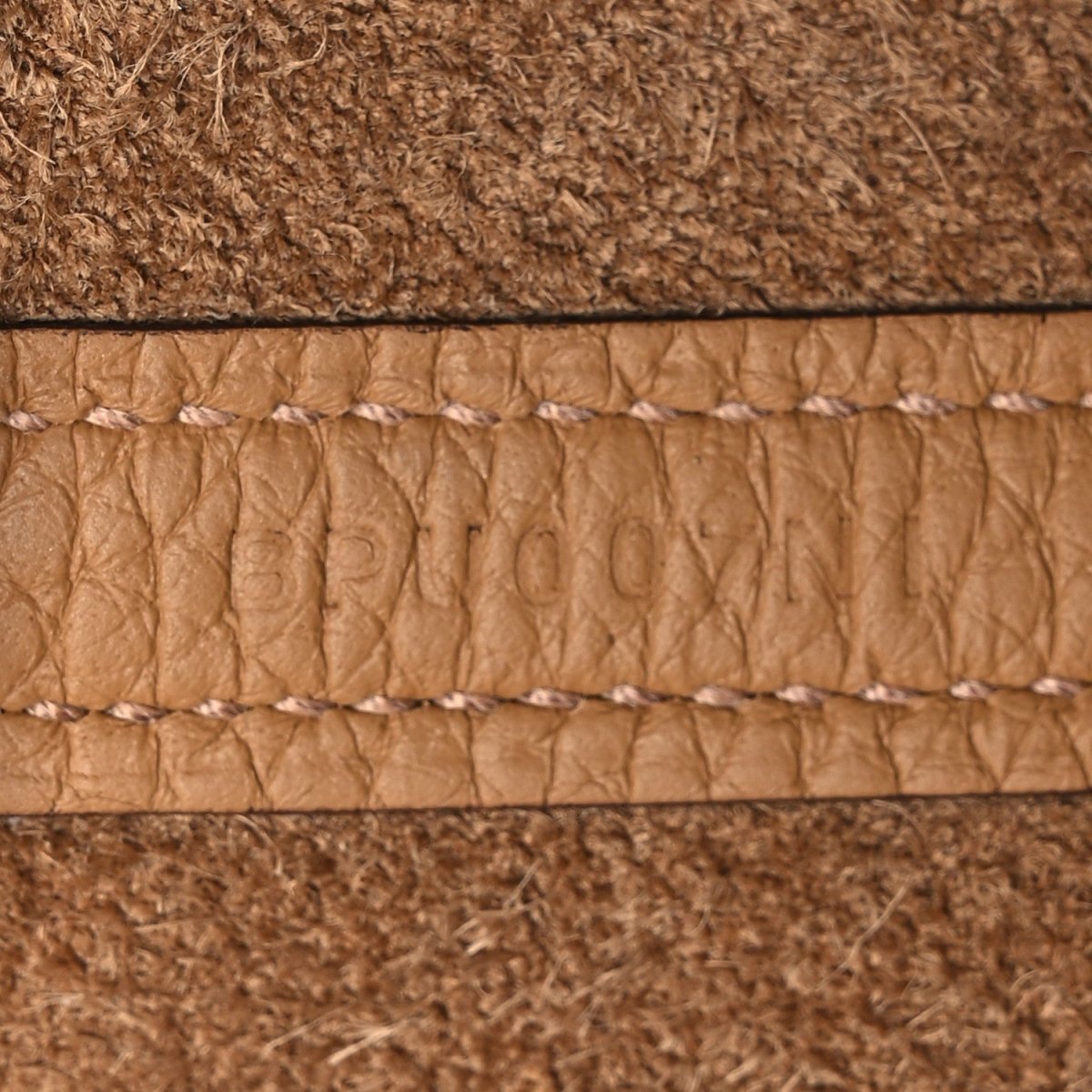 Leather edge trim with white edge stitching and textured lining