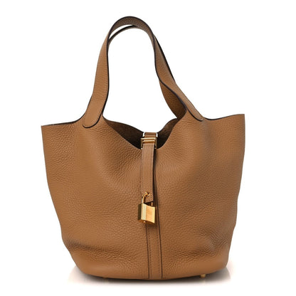 Pebbled leather tote bag with top handles and gold lock clasp, front view, biscuit.