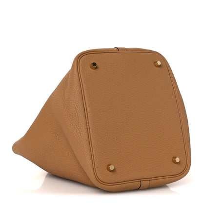 Pebbled leather tote bag corner view with metal studs, biscuit tan.