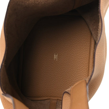Leather tote interior with pebbled finish and small stamped logo, biscuit lining.