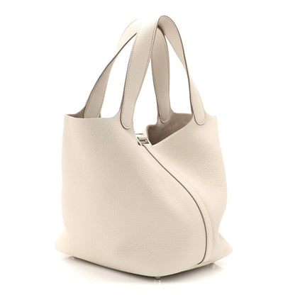 Off-white leather bucket bag from back/side with curved silhouette and handles