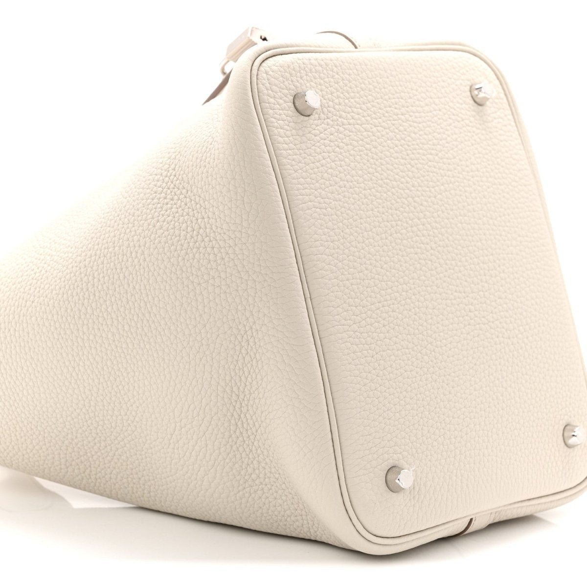 Off-white leather bucket bag angled view with front lock strap and stud hardware