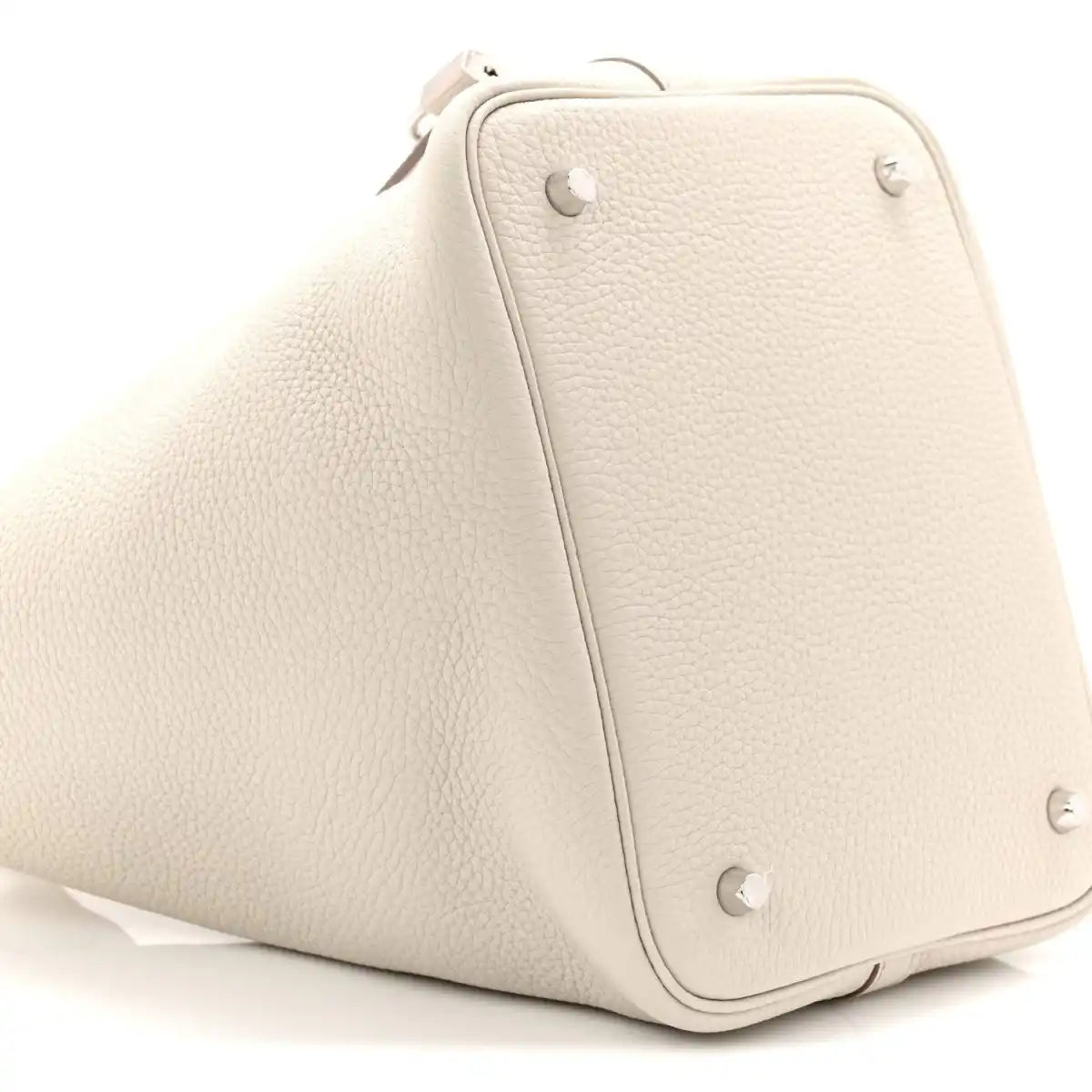 Off-white leather bucket bag angled view with front lock strap and stud hardware