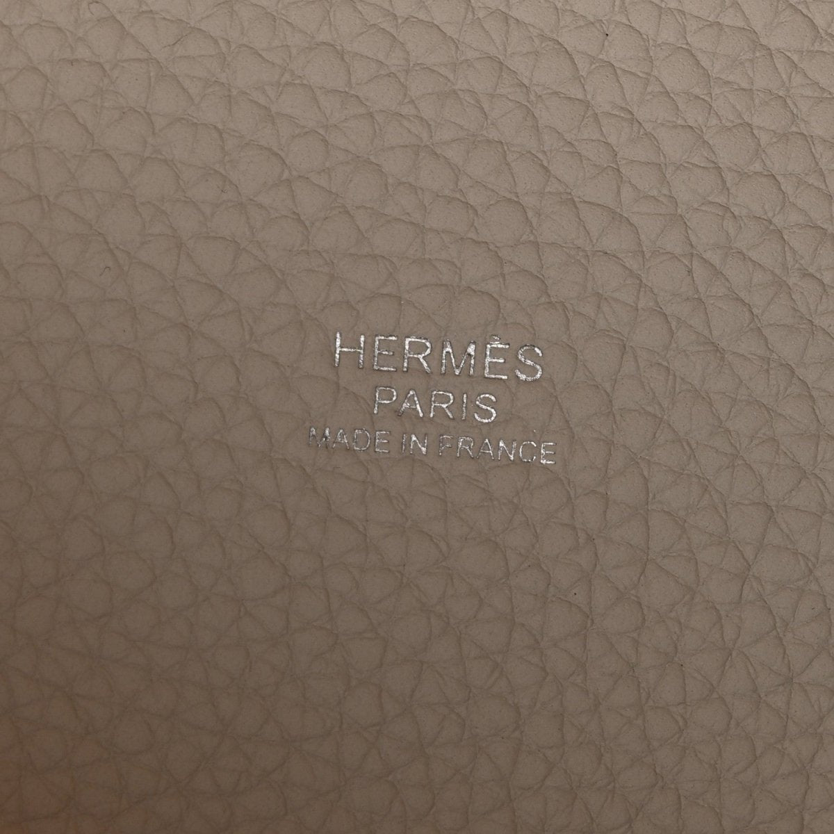 Off-white leather bag base with embossed brand text HERMES PARIS