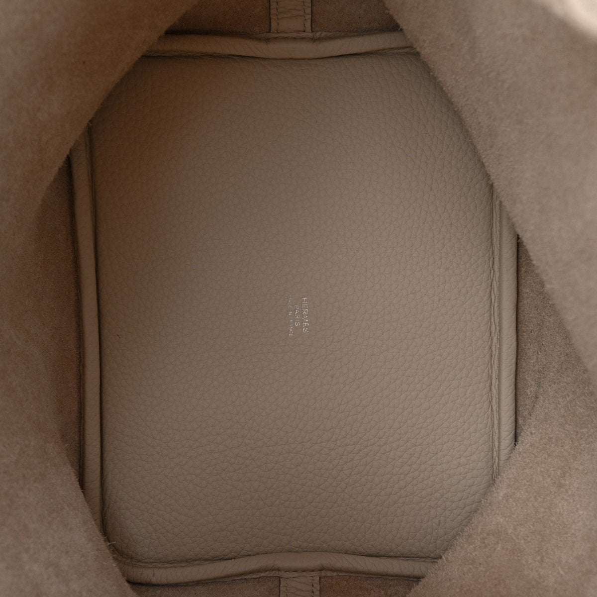 Off-white leather bucket bag interior with smooth lining and molded side walls