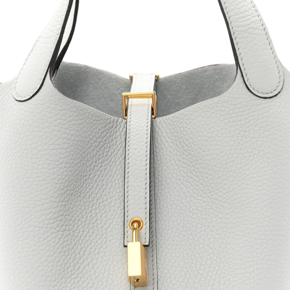 Light blue pebbled leather tote top with gold-toned lock hardware and zipper track