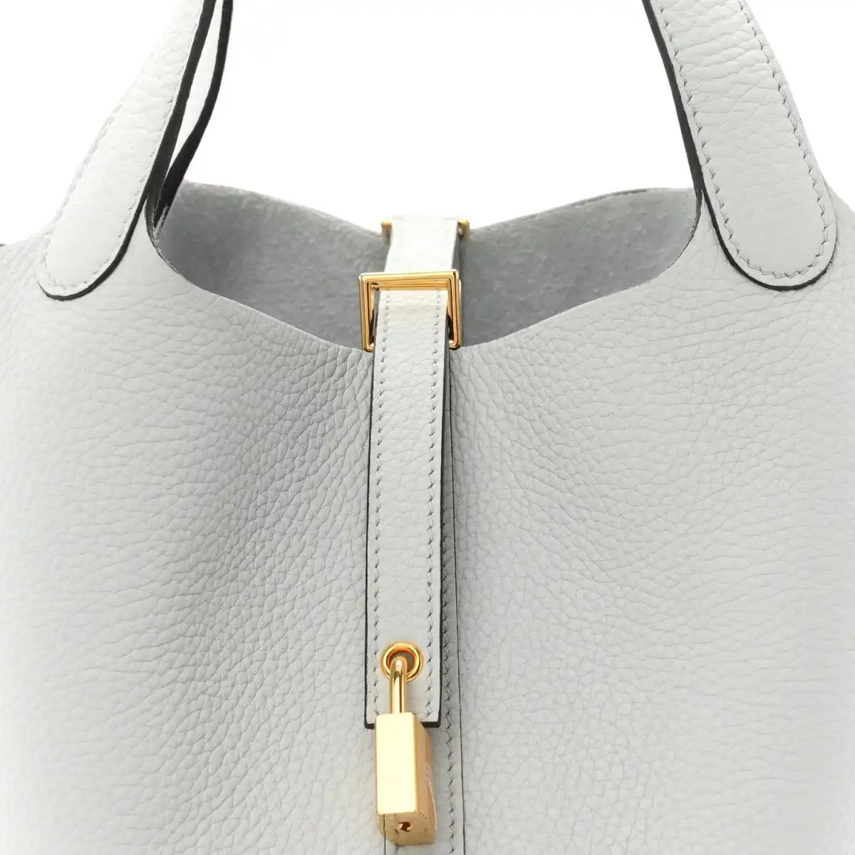 Light blue pebbled leather tote top with gold-toned lock hardware and zipper track