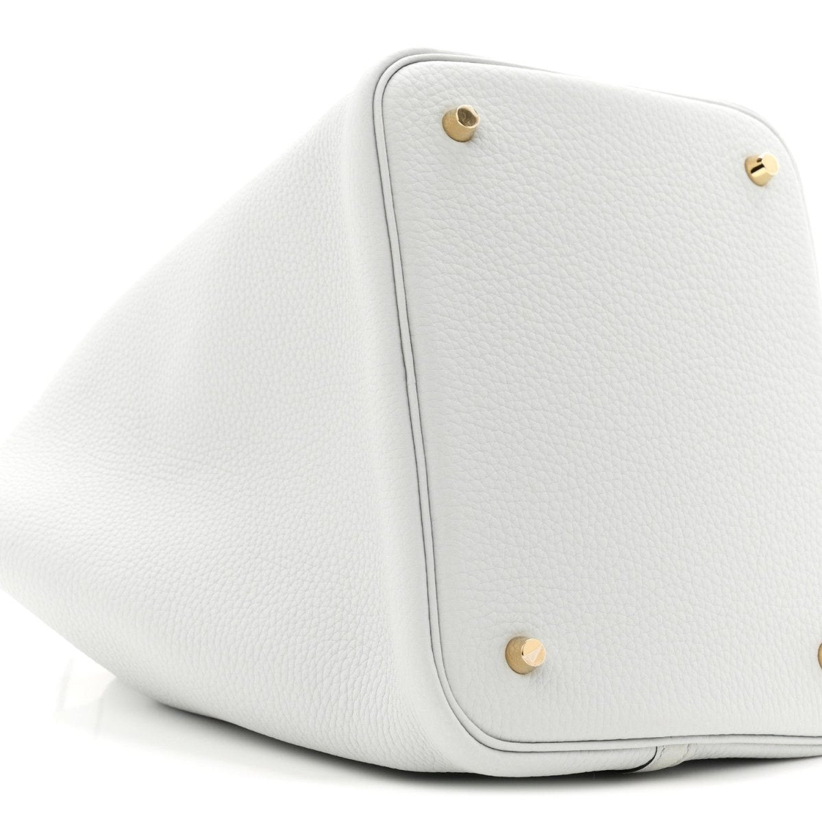 Light blue leather bucket tote with two gold-toned snap buttons and rounded shape