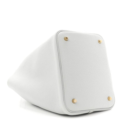 Light blue leather bucket tote corner with snap buttons and curved edge