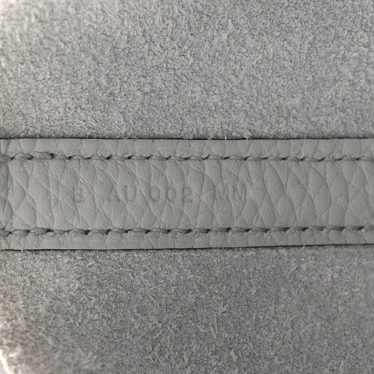 Light blue leather tote stitching detail along the seam and edge