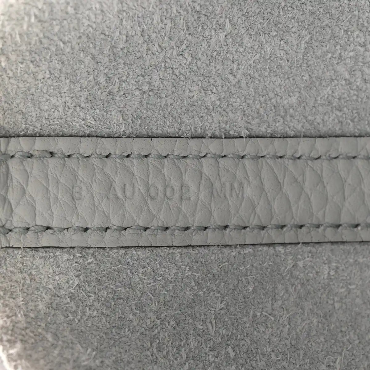 Light blue leather tote stitching detail along the seam and edge