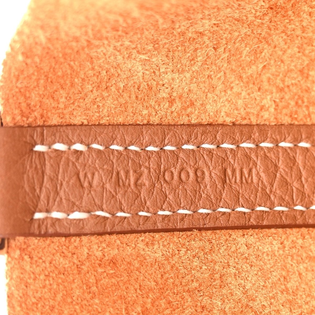 Tan leather edge with white braided stitching detail