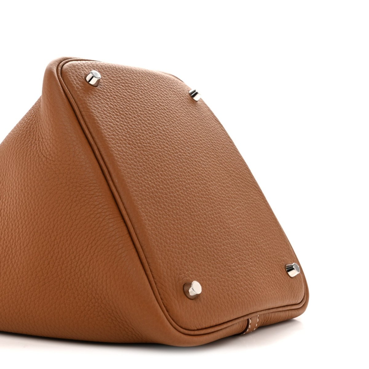 Tan leather tote bag corner with silver feet studs and stitched seam