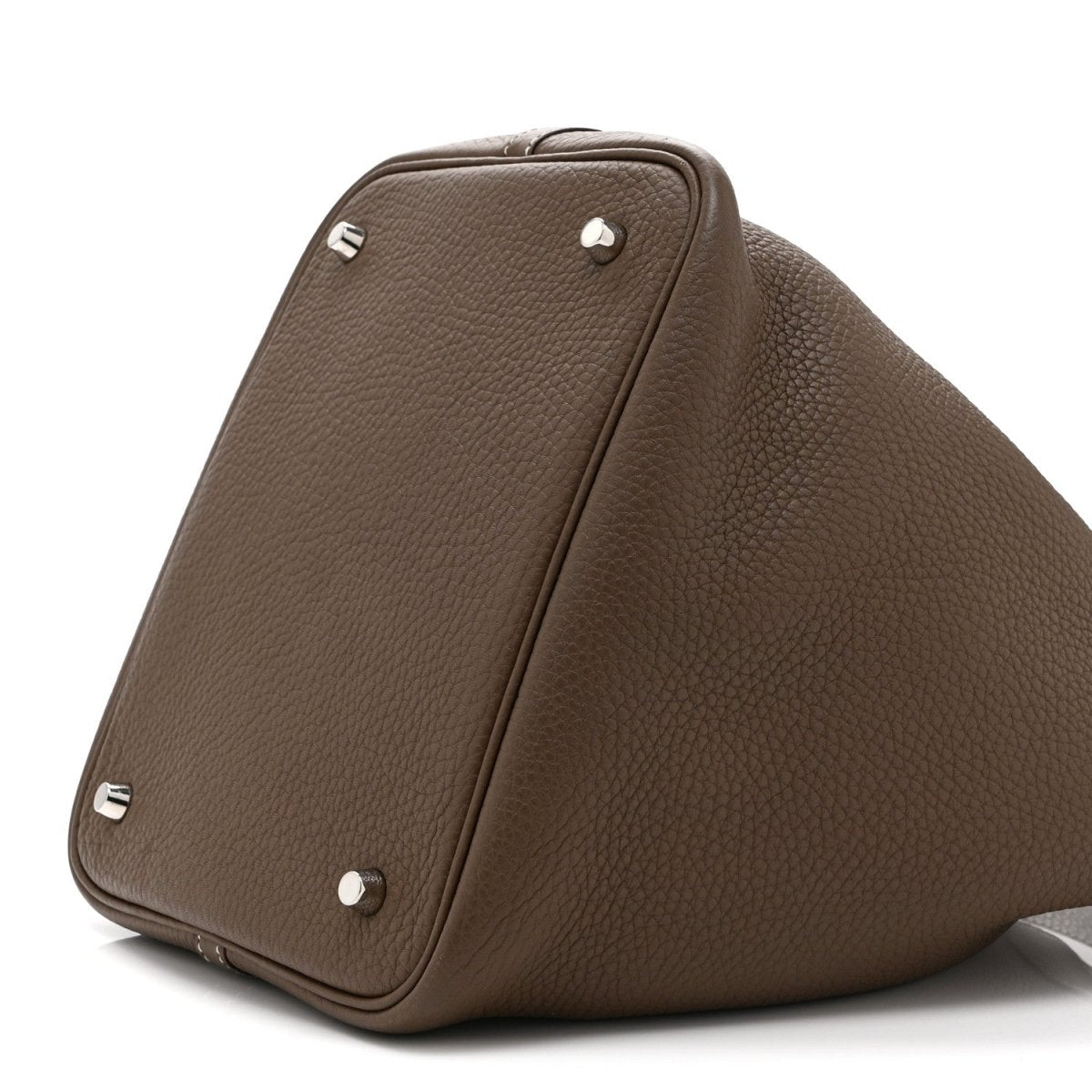 Taupe leather tote bag corner with metal studs and snap-closure seam