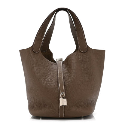 Taupe leather tote bag with two top handles and central lock clasp
