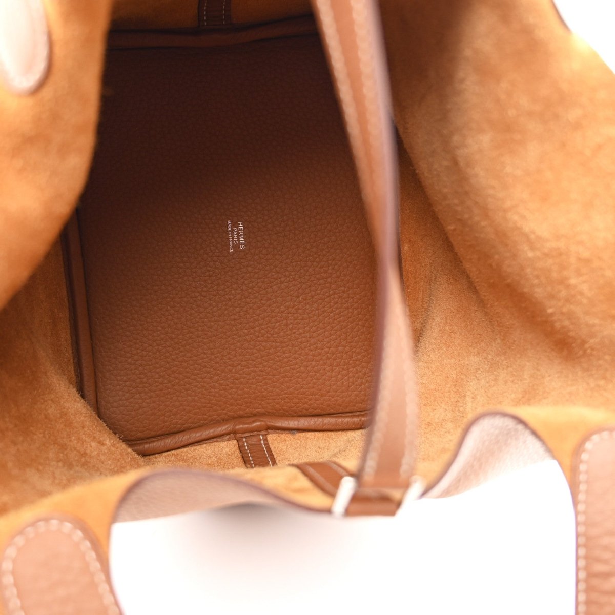 Tan leather tote interior with stitched lining and inner pocket
