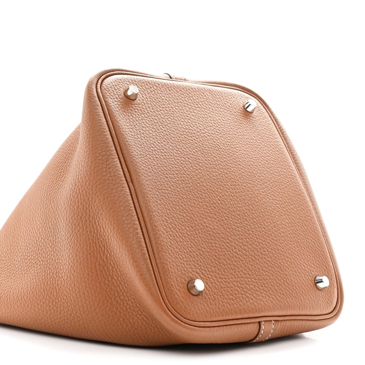 Tan leather tote bag with triangular flap and metal snap studs