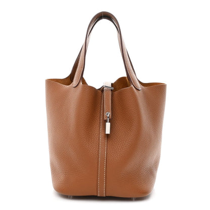 Tan leather tote bag with top handles and central lock closure
