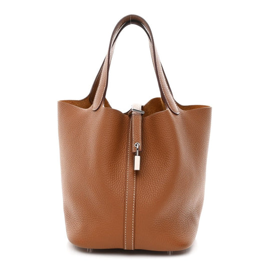 Tan leather tote bag with top handles and central lock closure