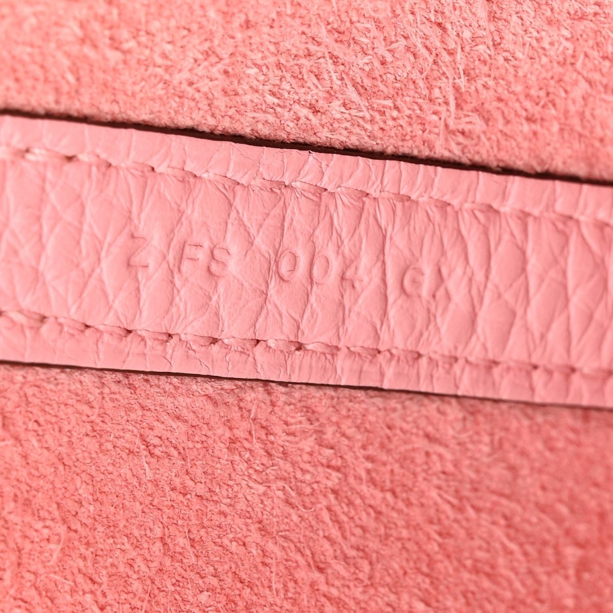 Rose leather edge with stitched trim and recessed embossing detail