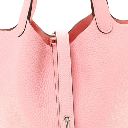 Rose pink leather bucket bag front with vertical zip pull and loop ring