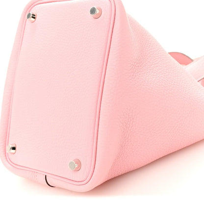 Rose pink leather bucket bag side with metal eyelets and stitched panel