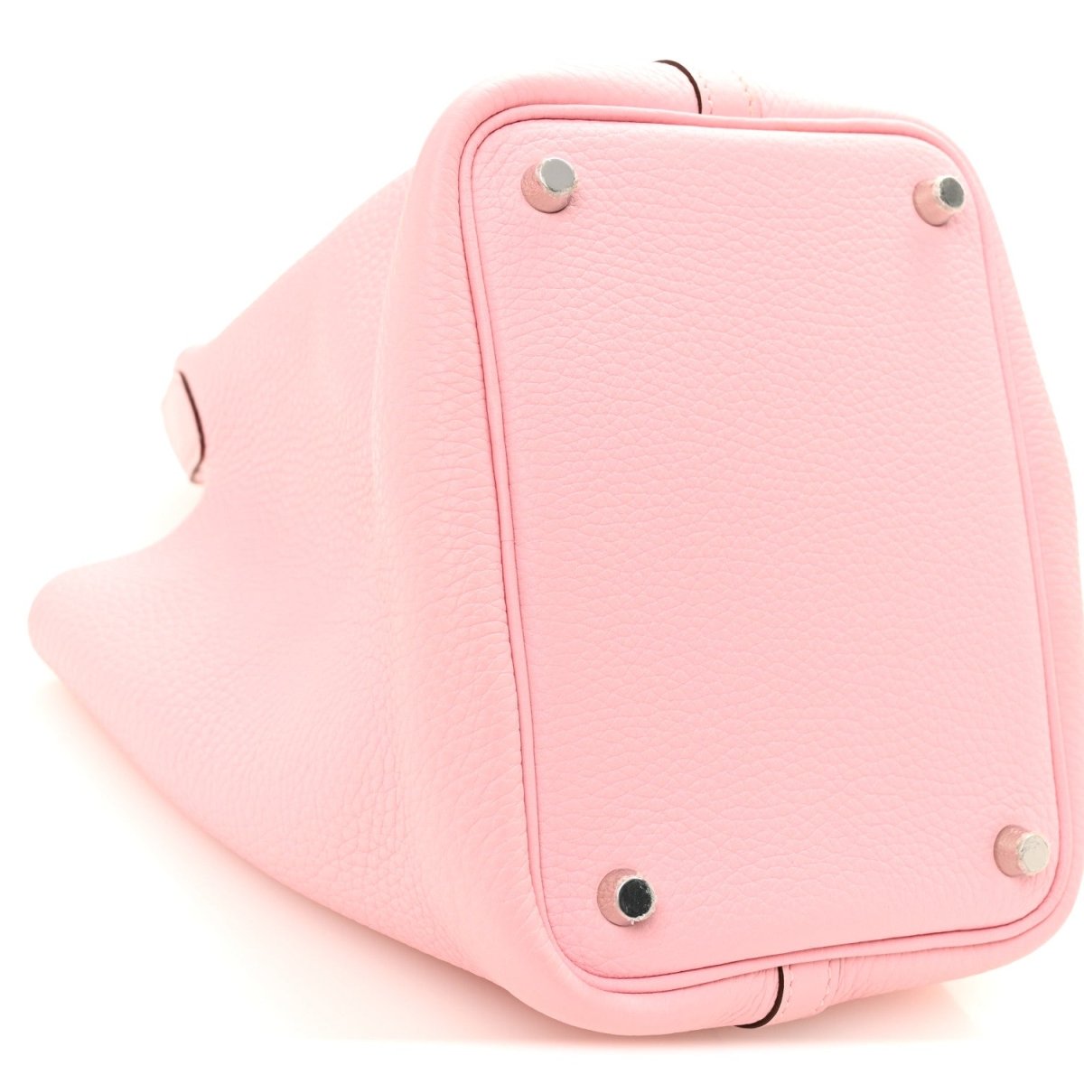 Rose pink leather bucket bag corner with metal studs and curved base