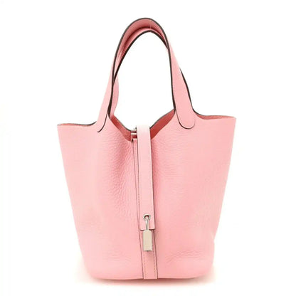 Rose pink leather bucket bag with top handles and central lock clasp