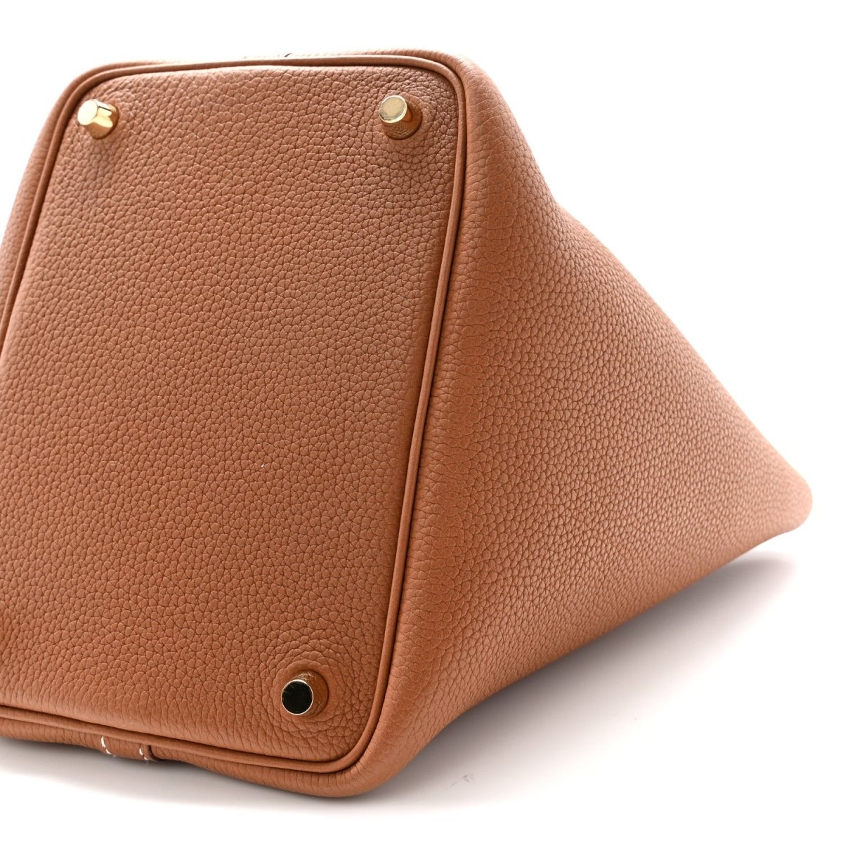 Tan leather Picotin-style handbag corner view with gold feet and textured finish