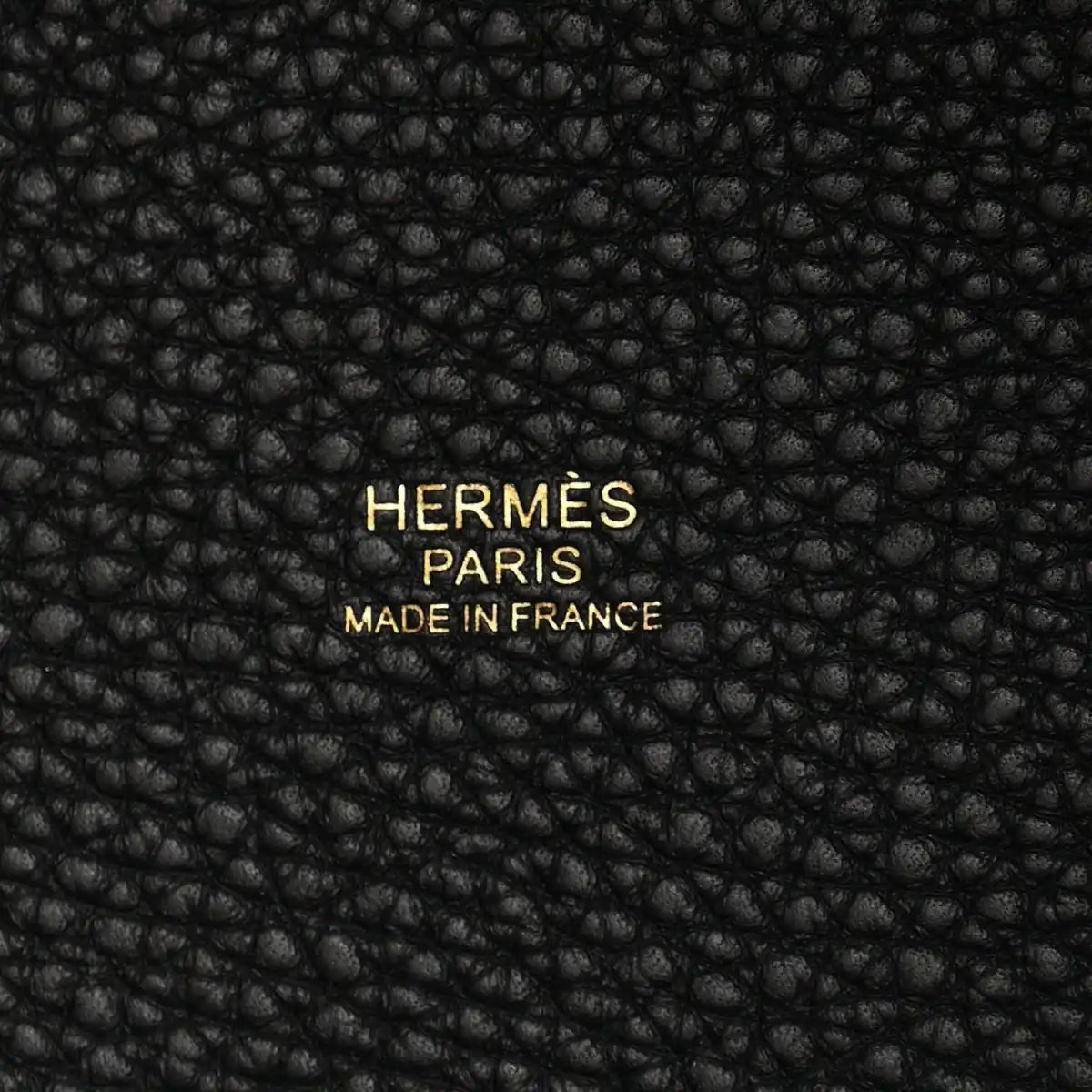 Black leather tote panel with embossed “HERMES PARIS MADE IN FRANCE” text.