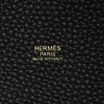 Black leather tote panel with embossed “HERMES PARIS MADE IN FRANCE” text.