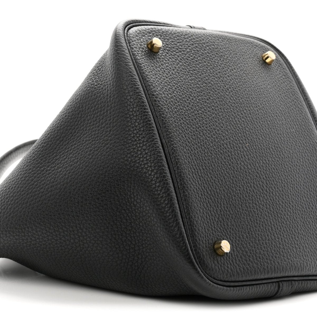 Black leather top-view of tote with gold-tone studs and front corner stitching.