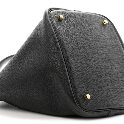 Black leather top-view of tote with gold-tone studs and front corner stitching.