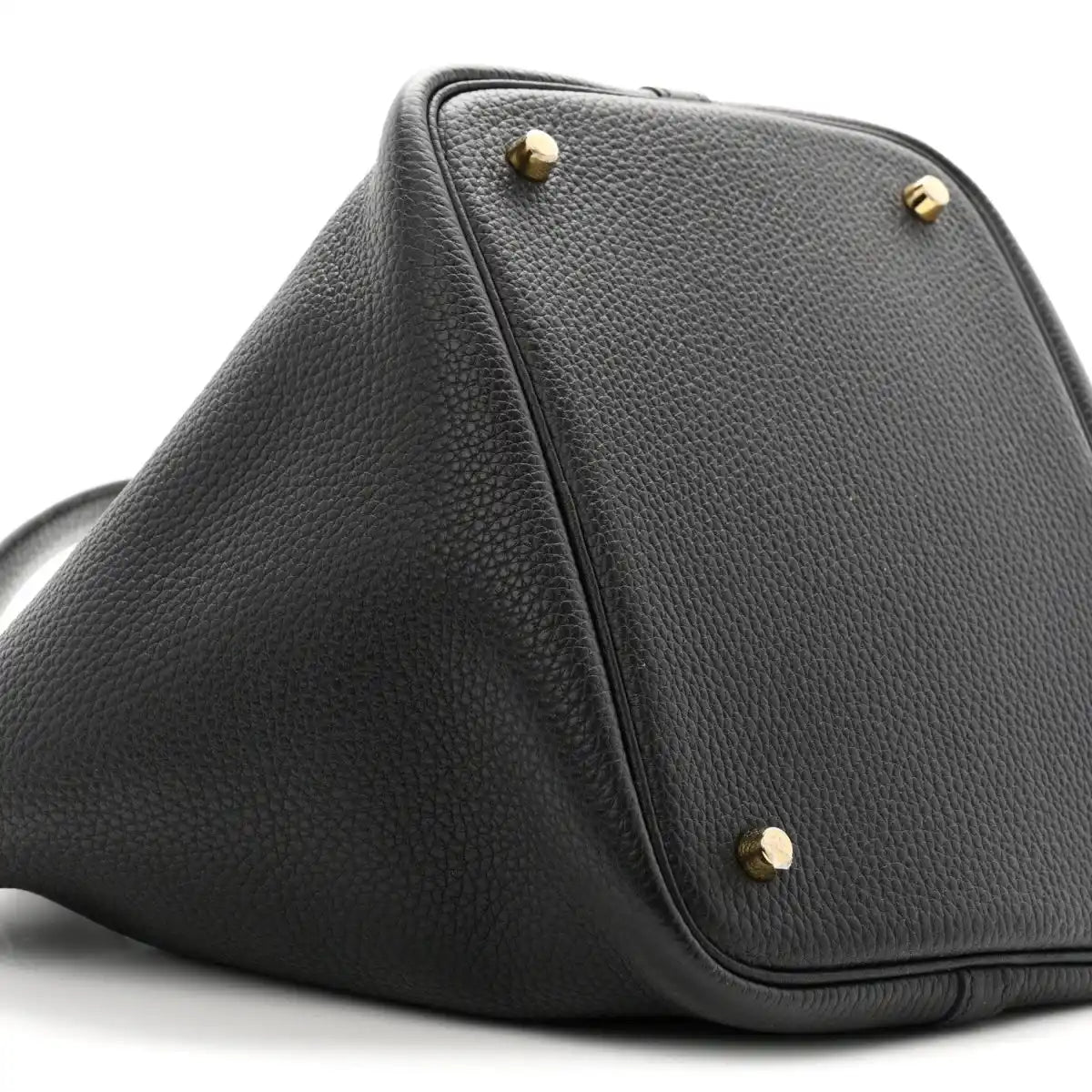 Black leather top-view of tote with gold-tone studs and front corner stitching.