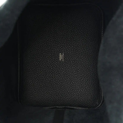Black leather tote, textured grain with central stamped branding.