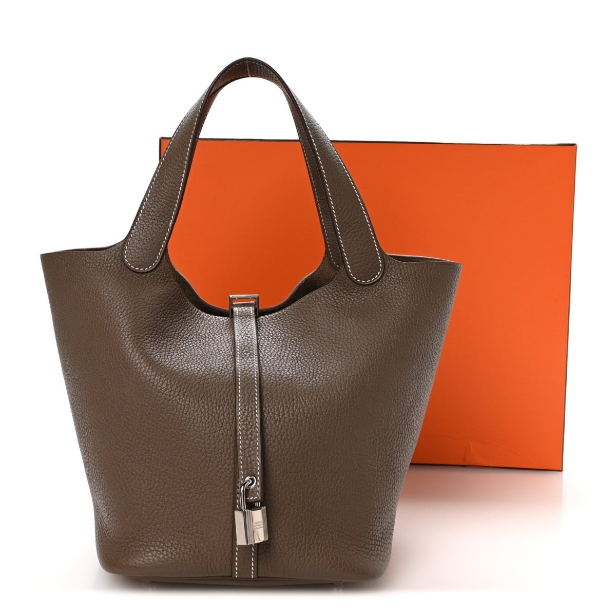 Taupe leather tote-style handbag with central lock and top handles