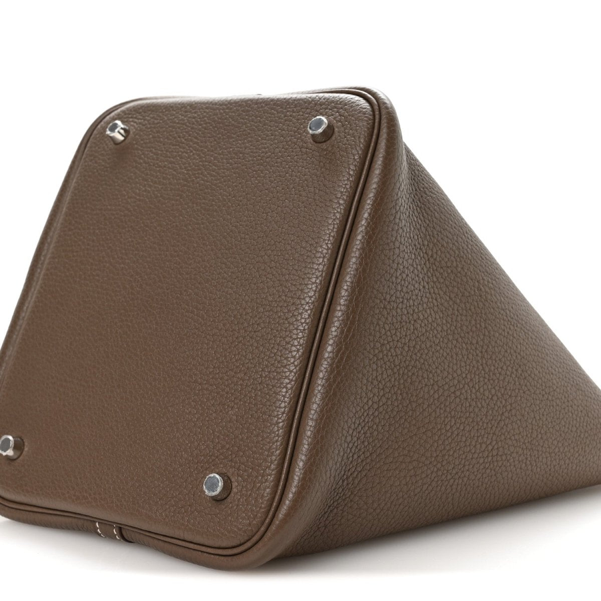 Taupe leather handbag corner view with metal feet and stitched edge trim