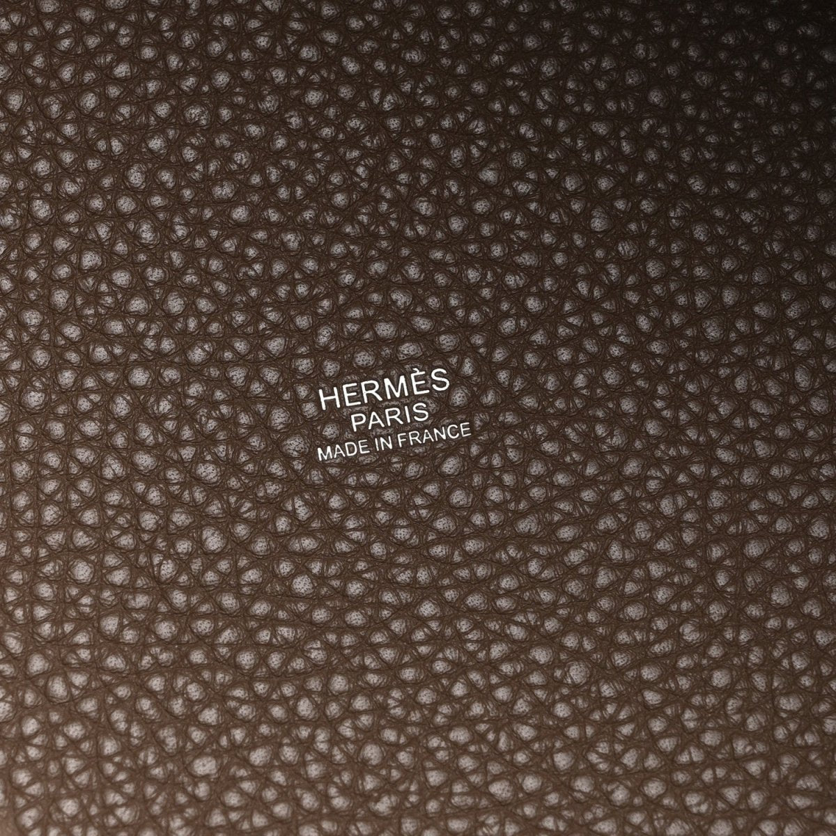 Hermès Paris stamp and Made in France on taupe textured leather lining