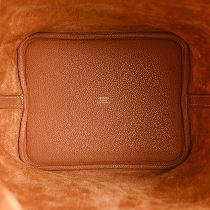 Tan leather interior pocket with stitched edges and small Hermes branding