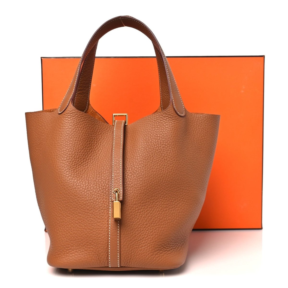Leather tote bag with top handles and gold lock, tan/brown textured finish.