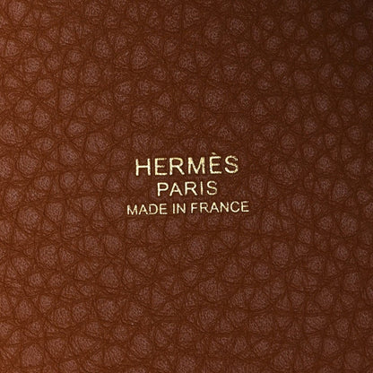 HERMES PARIS label on leather lining with MADE IN FRANCE text, brown textured leather.