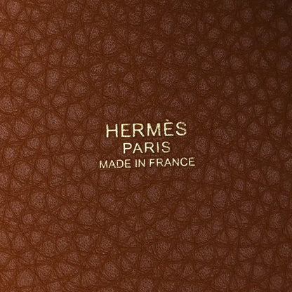 HERMES PARIS label on leather lining with MADE IN FRANCE text, brown textured leather.