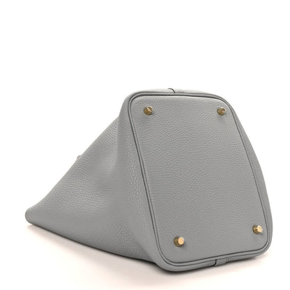 Grey leather tote bag with triangular fold and gold corner hardware