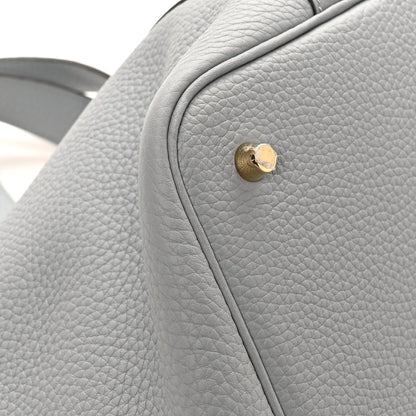 Grey leather tote side with textured grain and gold snap button