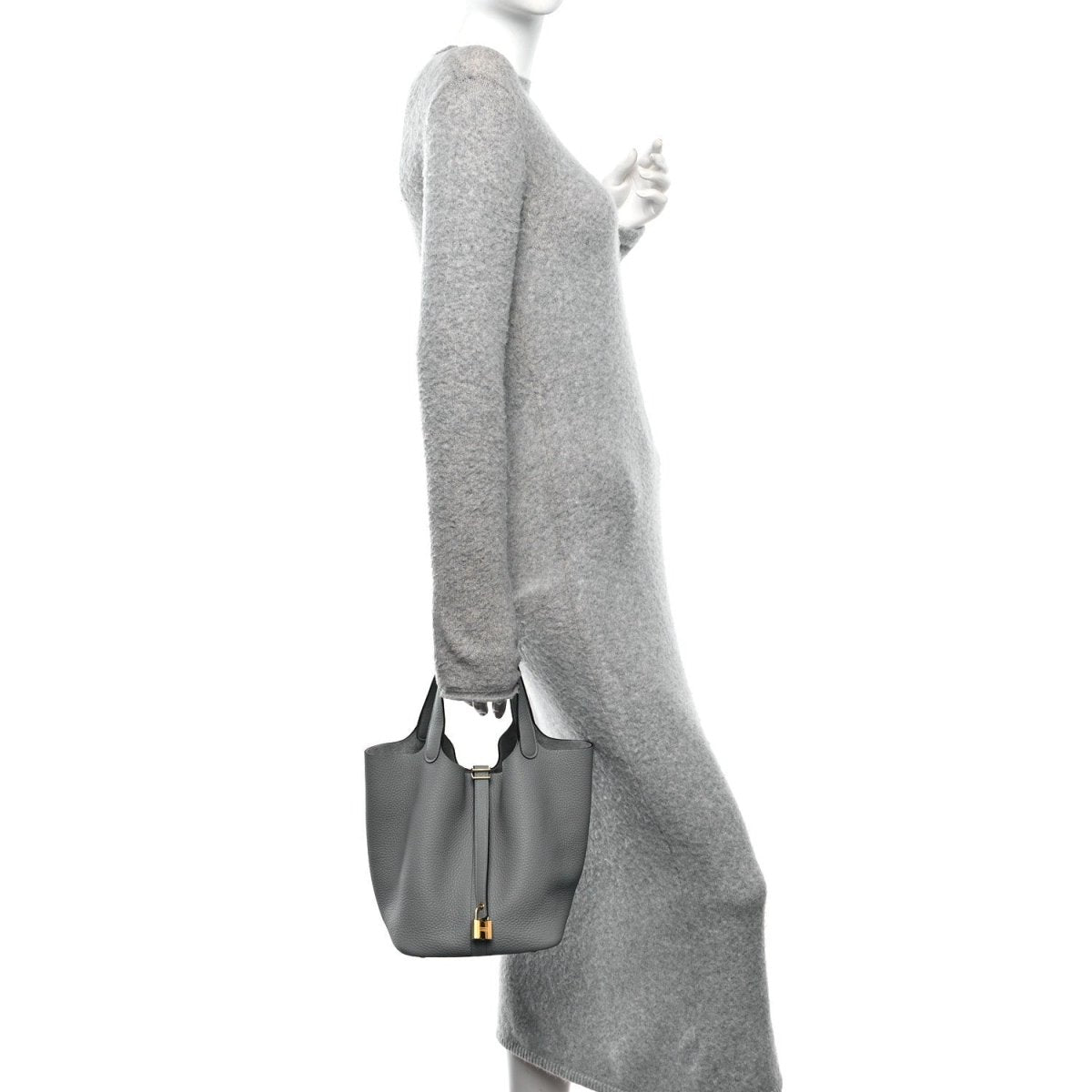 Grey leather tote bag held at the side with gold hardware and short handle