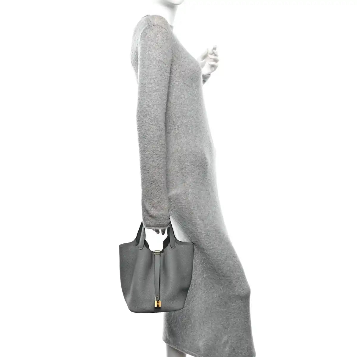 Grey leather tote bag held at the side with gold hardware and short handle