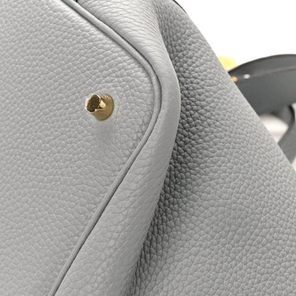 Grey leather tote corner with gold snap button and curved edge trim